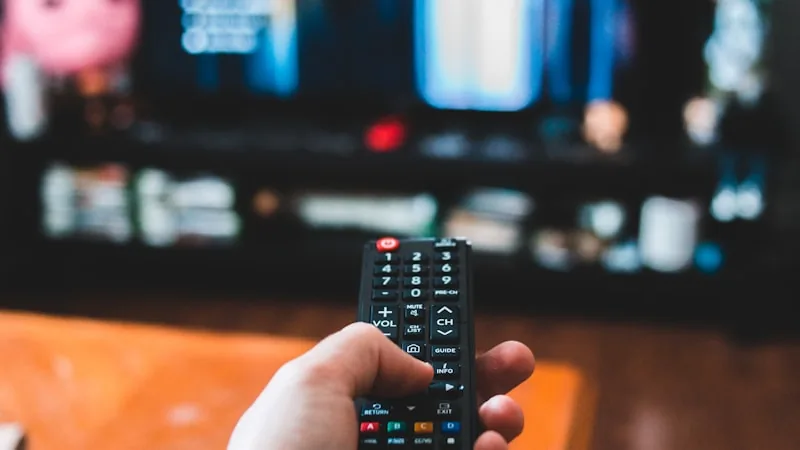 Split visual comparing a cable remote with a modern streaming device